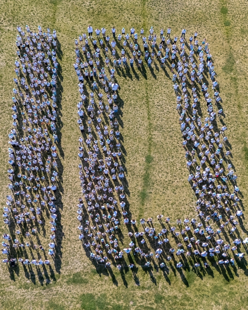 Students standing making the number ten.