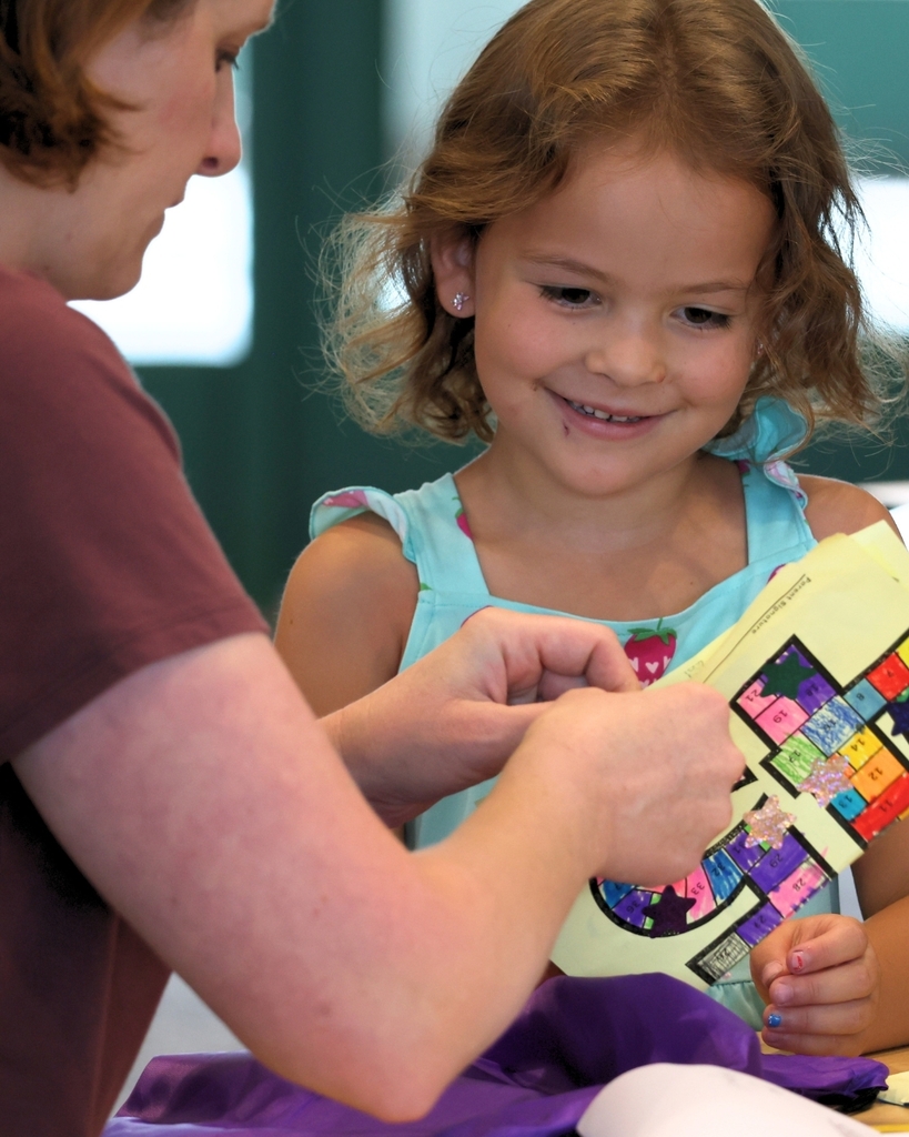 A student and parent reading a book.