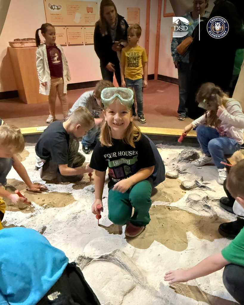 Students digging in the sand.
