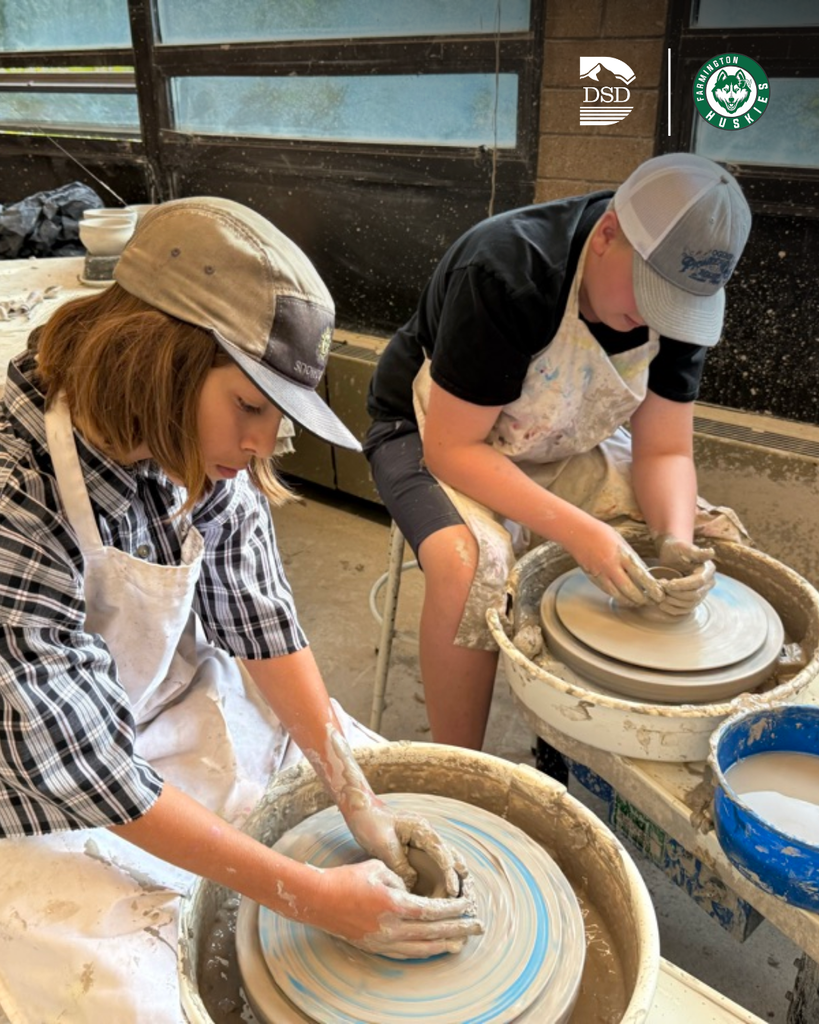 Students using a pottery wheel.