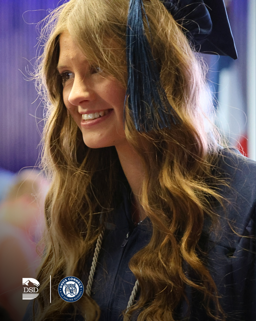 A graduate smiling.