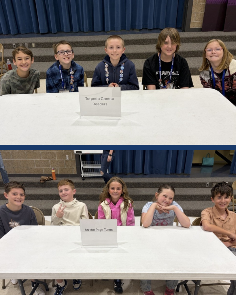 Students sitting at a table ready for book battles.