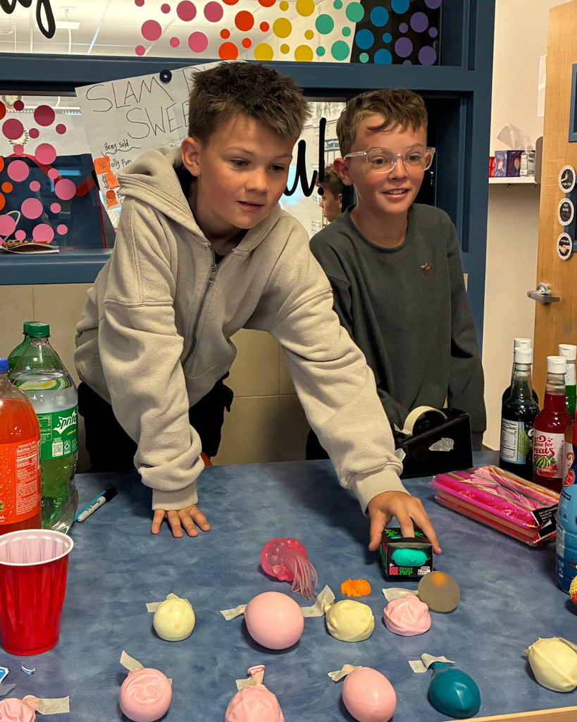 Students selling items for a school project.