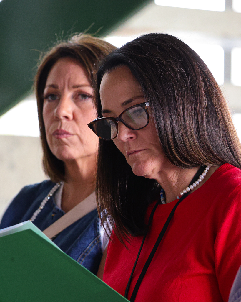 A Davis School District board member reading paperwork.
