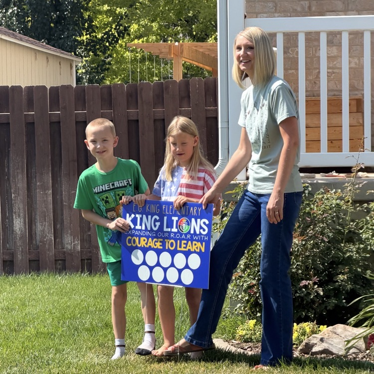 family putting up their yard sign 