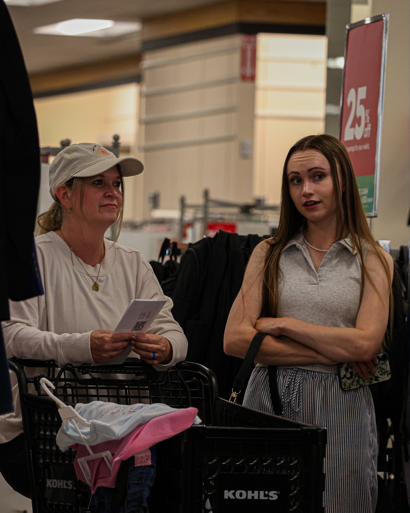 Two adults talking while shopping.