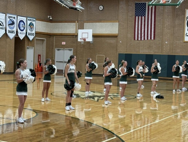 Cheerleaders perform in the gymnasium during Husky Camp.