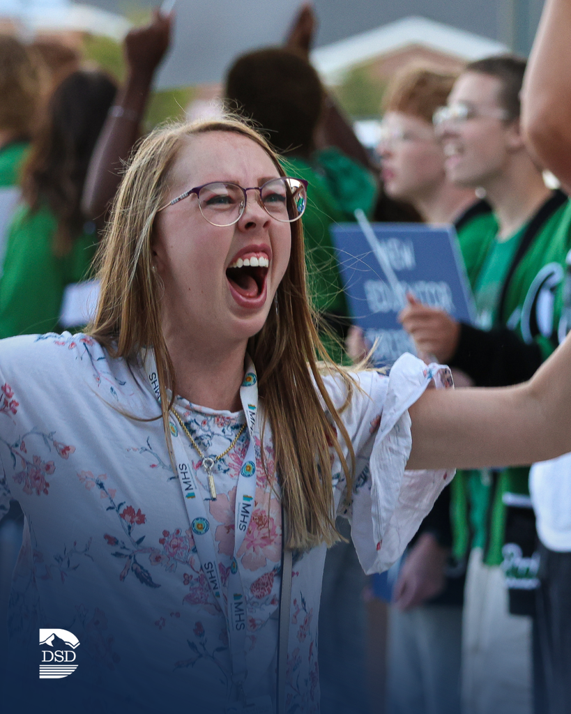 A new teacher celebrates as she walks into a school.