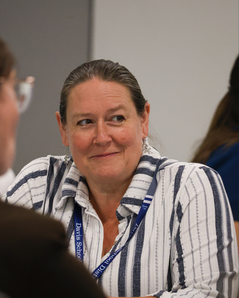 A teacher smiles during a lesson.