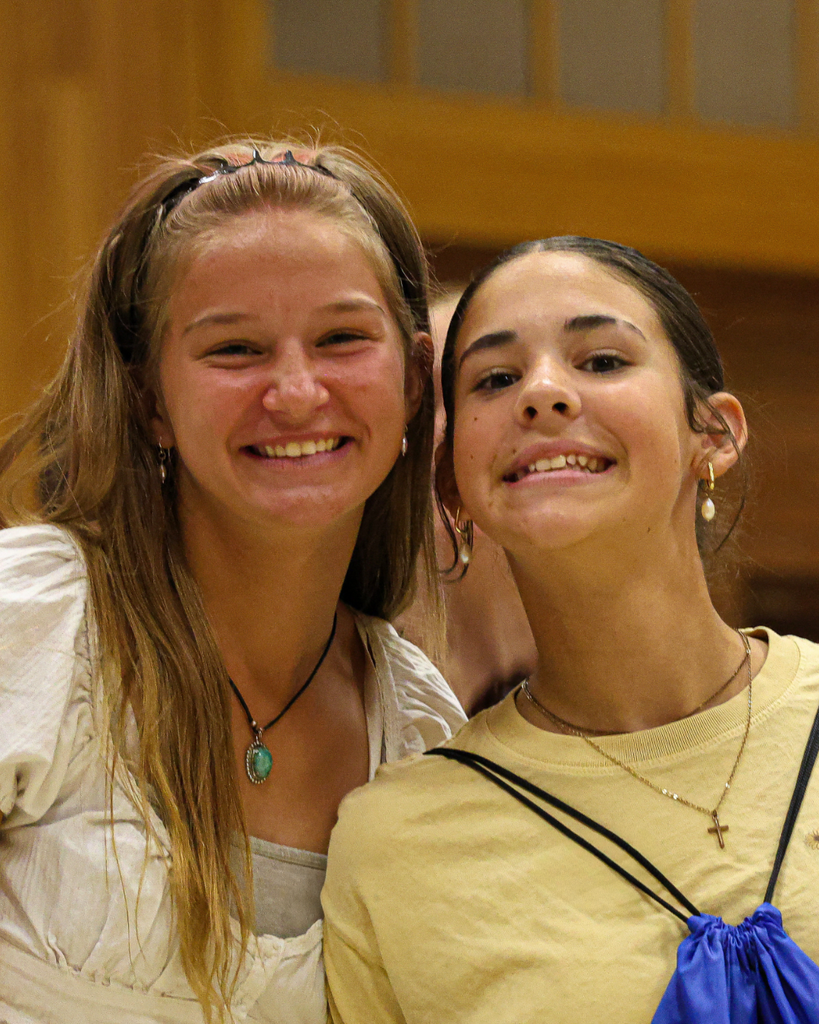 Two students smiling at the camera.