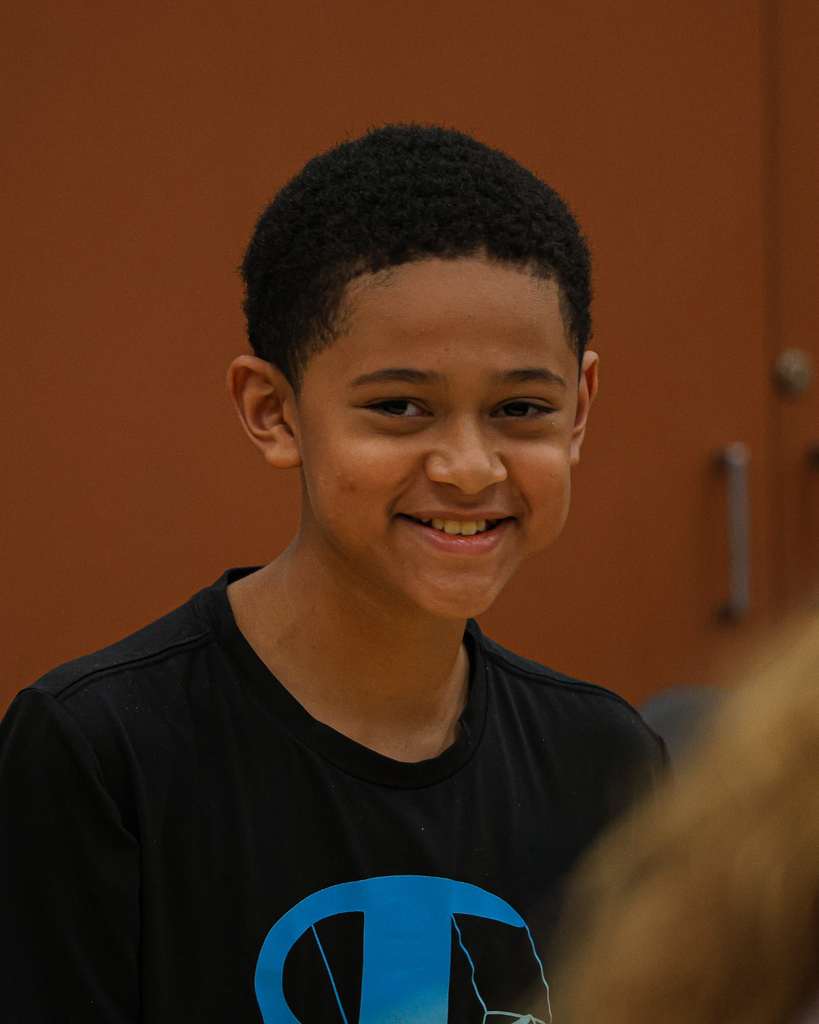 A student smiles happily.