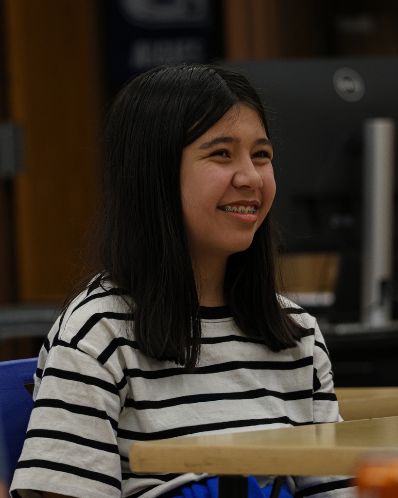 A student smiles in class.