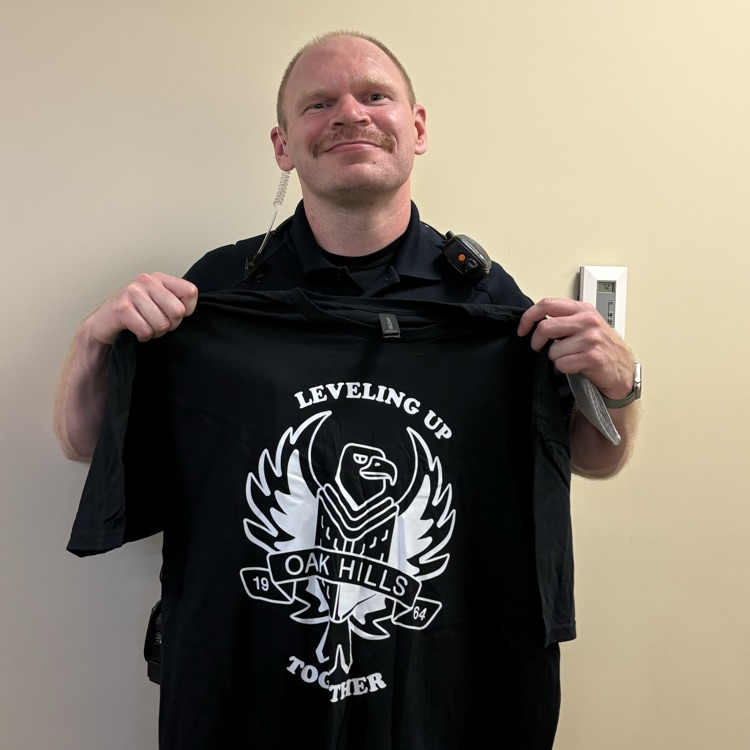 SRO holding up the school shirt