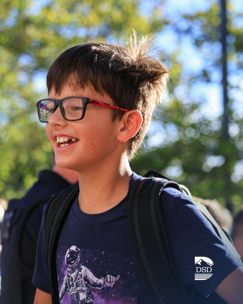A student smiling while walking into class.