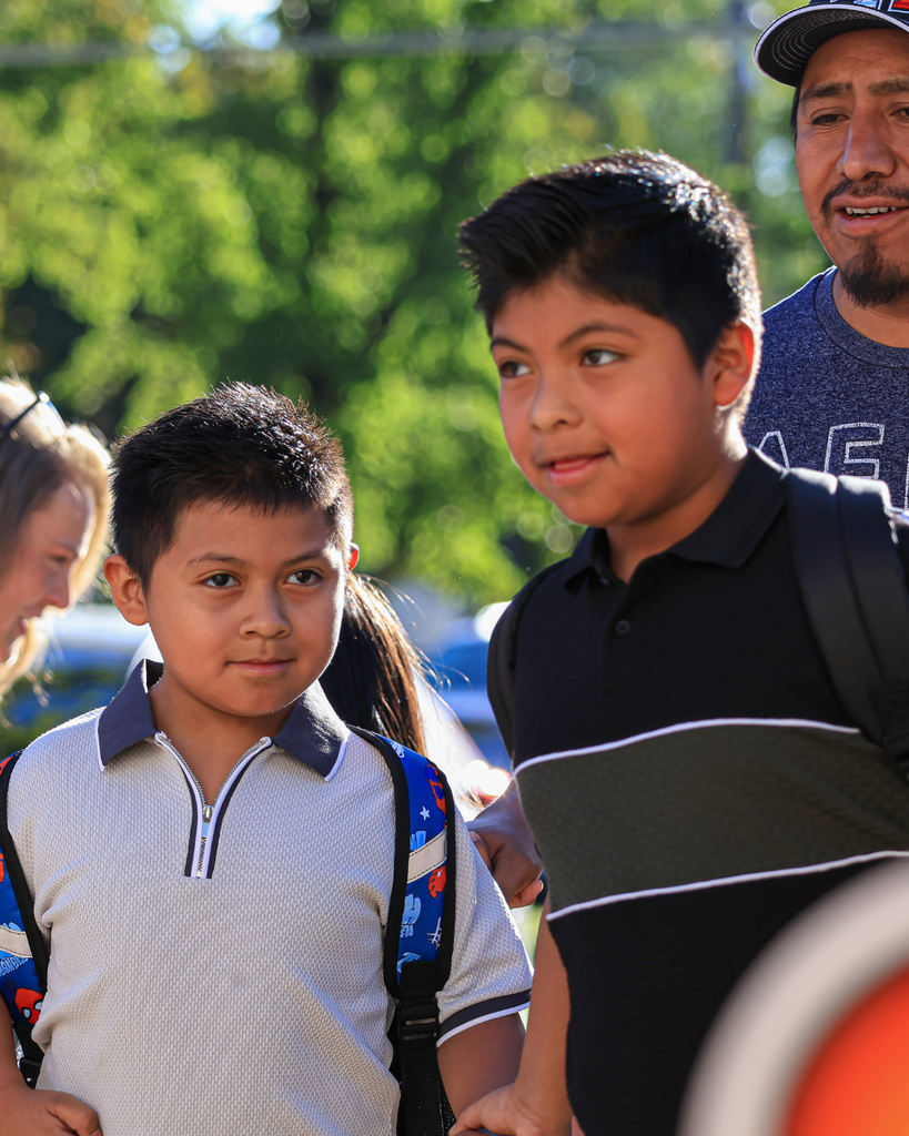 Two students walking into school.