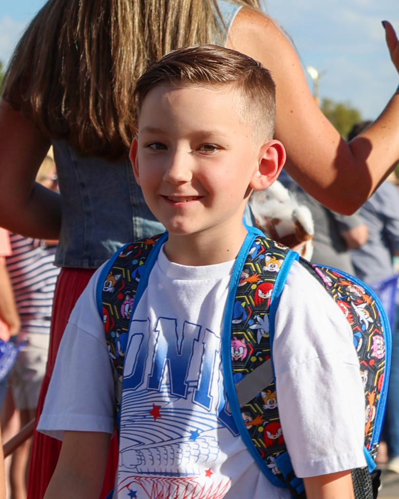 A student smiles at the camera.