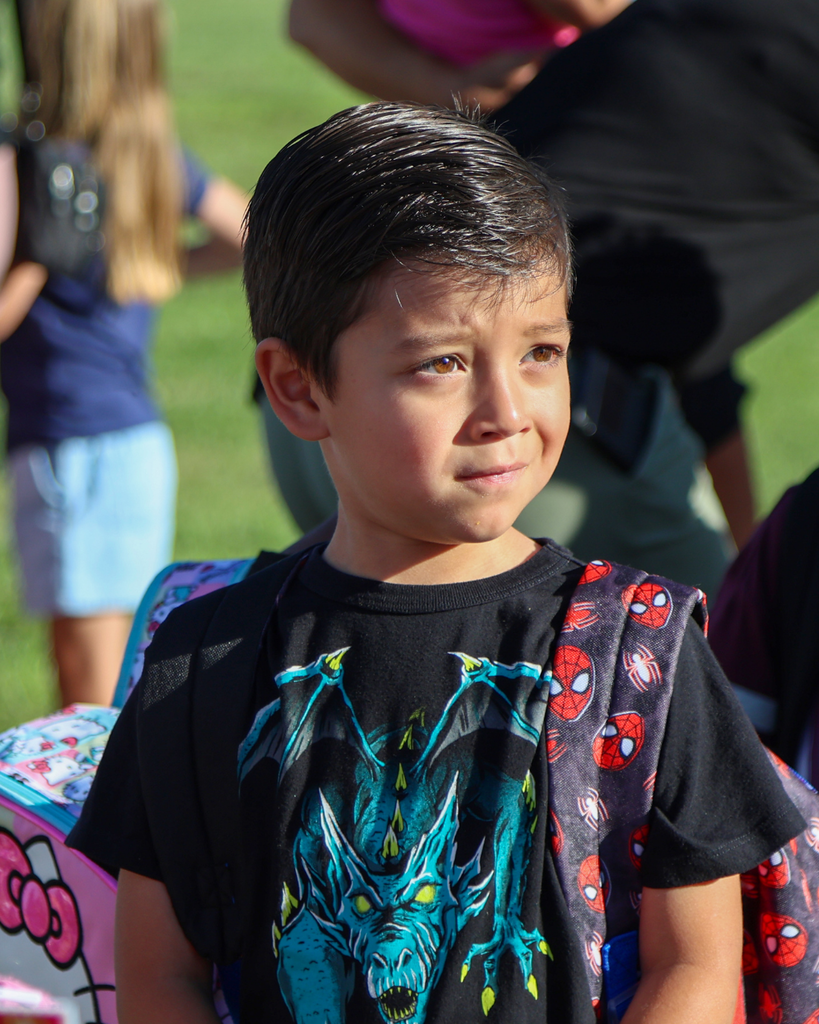 A student looks as they wait for school to start. 