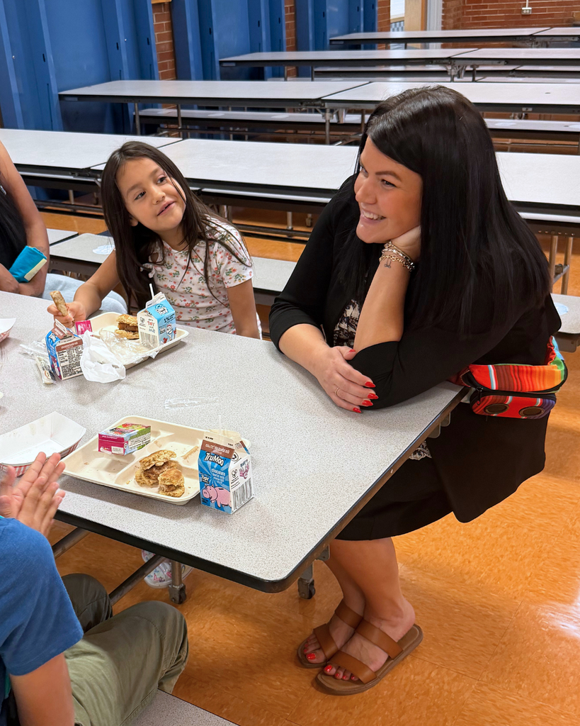 A principal speaking with students.
