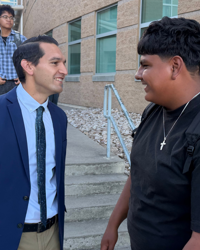 A principal speaking with a student.