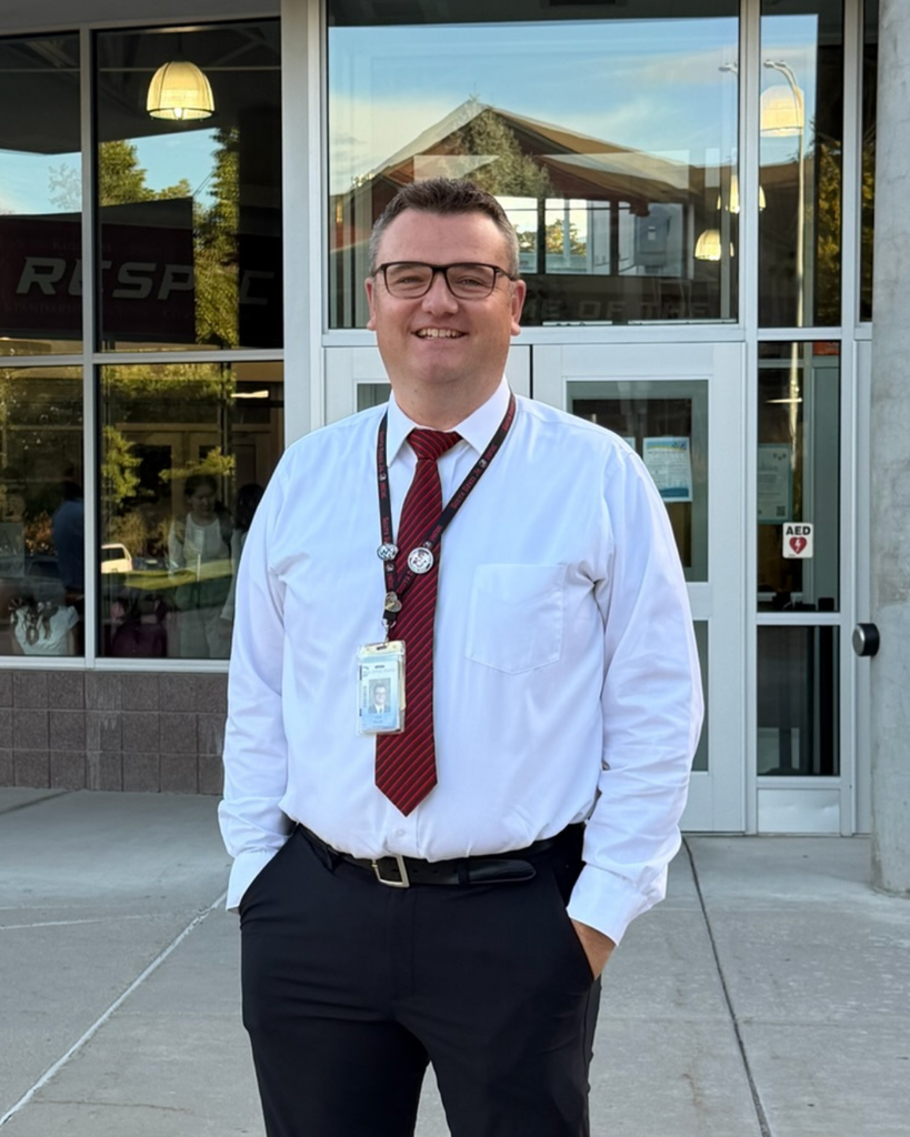 A principal smiling.