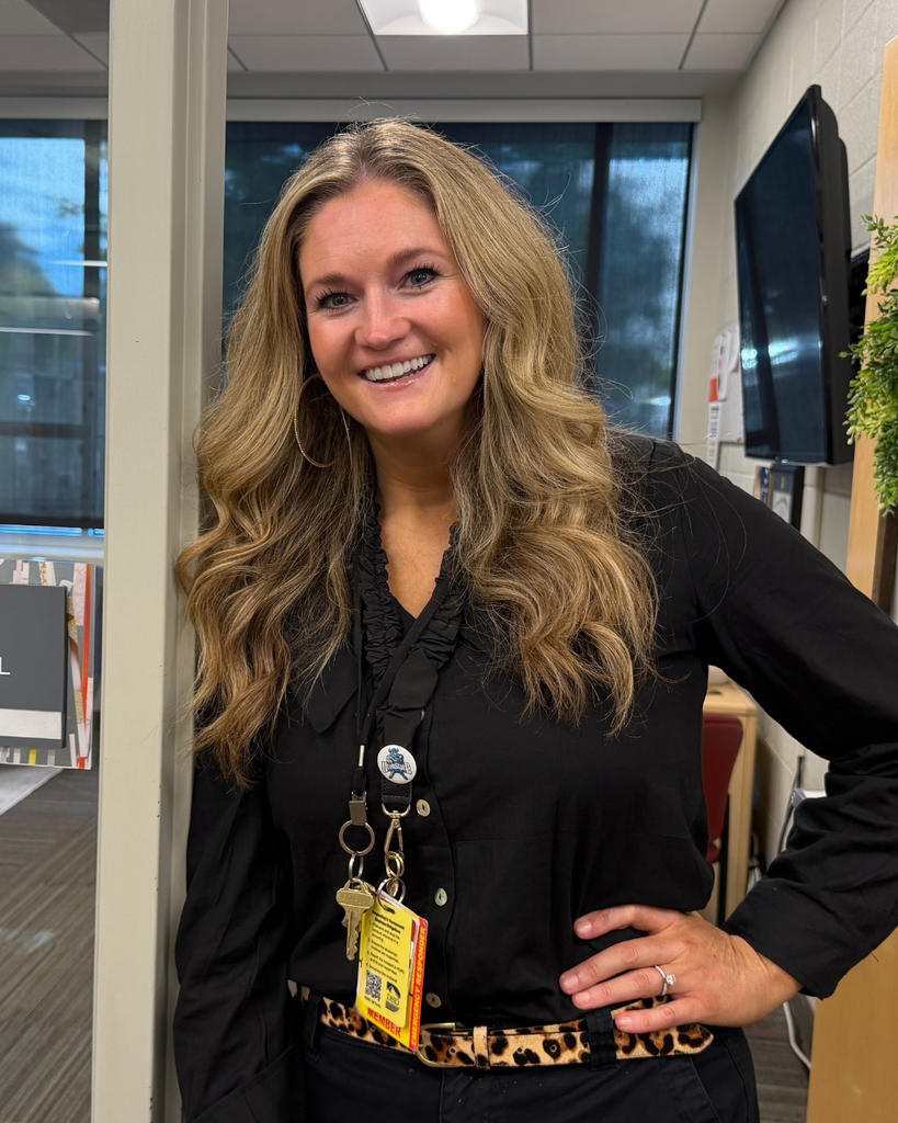 A principal smiling. 