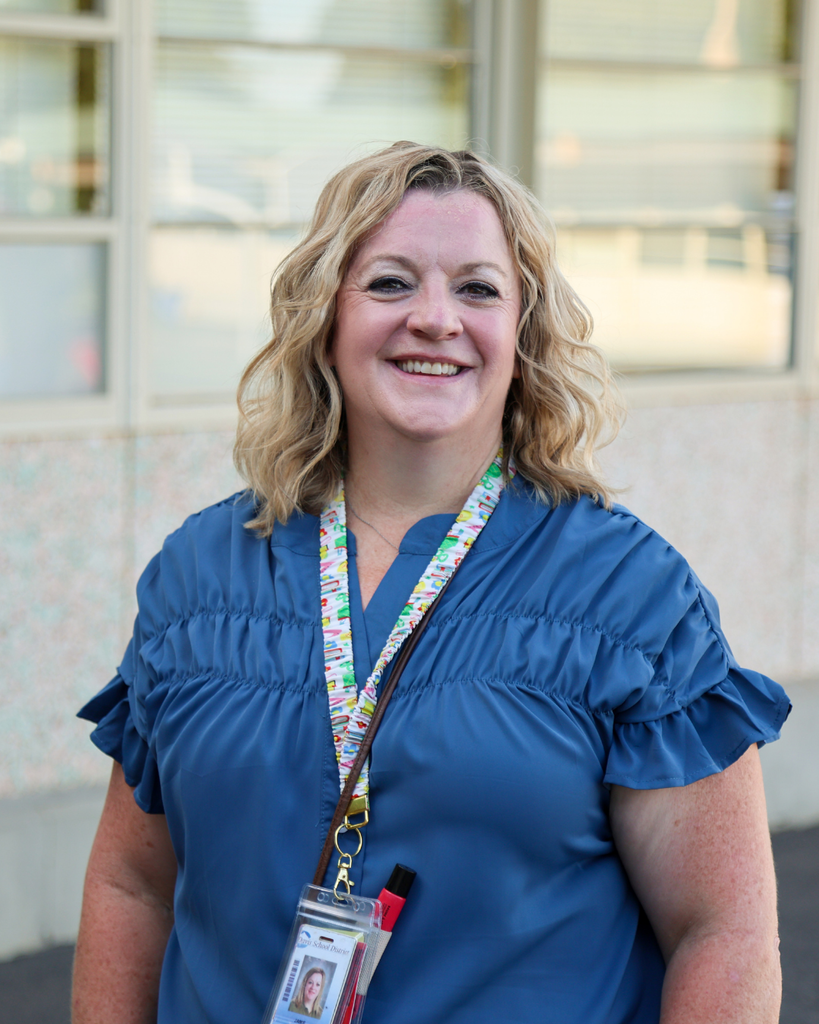 A principal smiling.