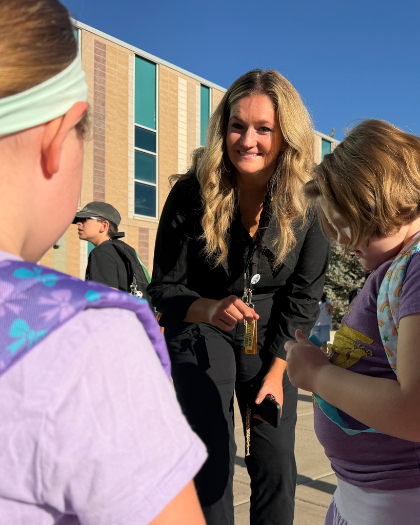 A principal talking with two students.