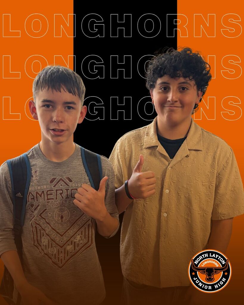 Two students are giving a thumbs up to the first day of school