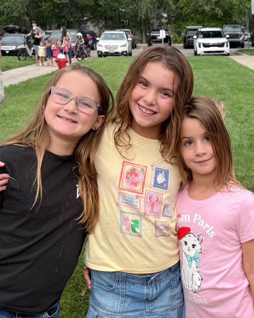 Three students smiling.