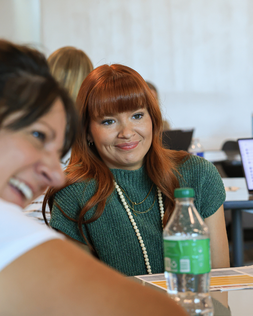 A teacher smiles during a conversation.