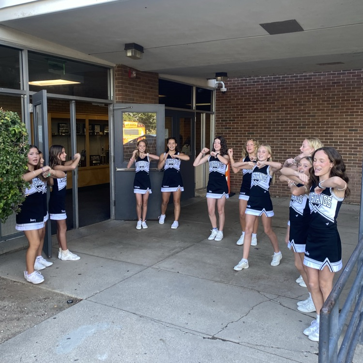 Cheerleaders welcoming students on the first day of school