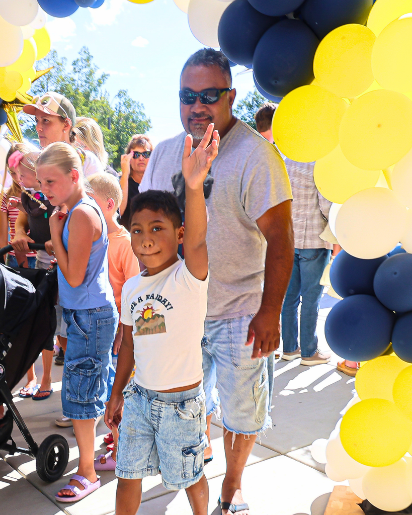 Families enter Burton Elementary school after ribbon cutting.