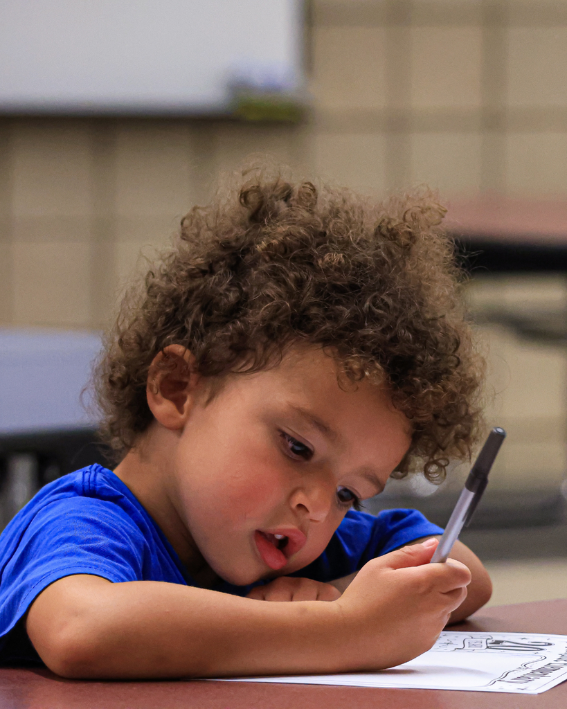 A student intently writing.