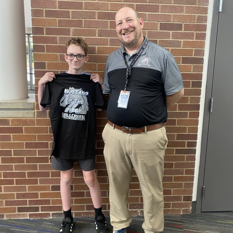 Principal and student celebrating the Mustang of the Week award