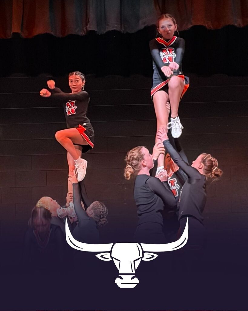 Cheerleaders perform on stage for the Back to School Assembly