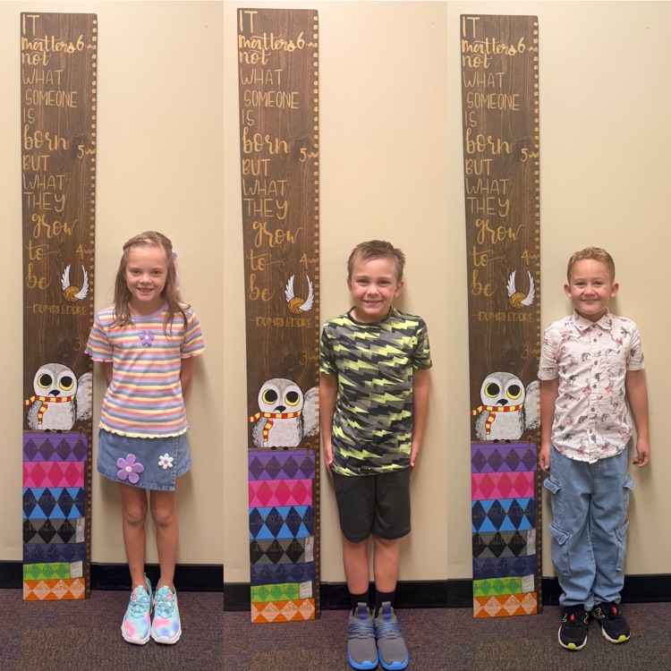 second graders on the first day of school - showing how tall they are 