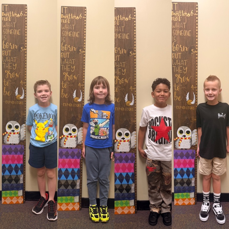 second graders on the first day of school - showing how tall they are 