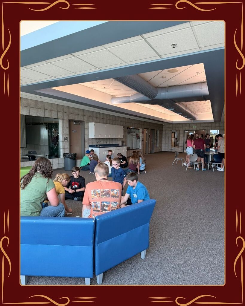 Three groups of students from West Point Junior High National Junior Honors Society are spread around the shared hallway, playing a variety of games. Some students are standing, some are sitting, and they all seem focused and excited to be there.
