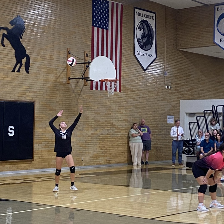 girl serving volleyball 