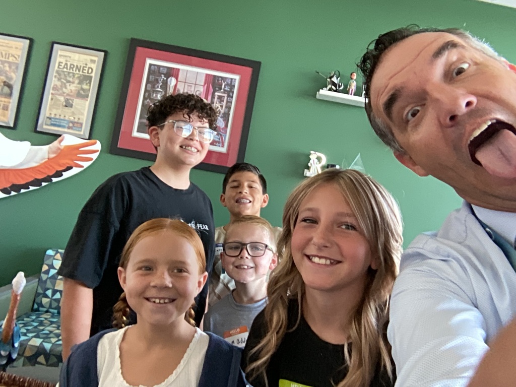 5 students smiling with man sticking out his tongue