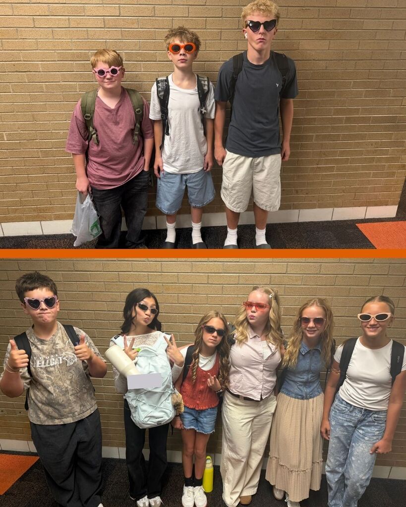 two groups of students stand in the hallway showing off their sunglasses