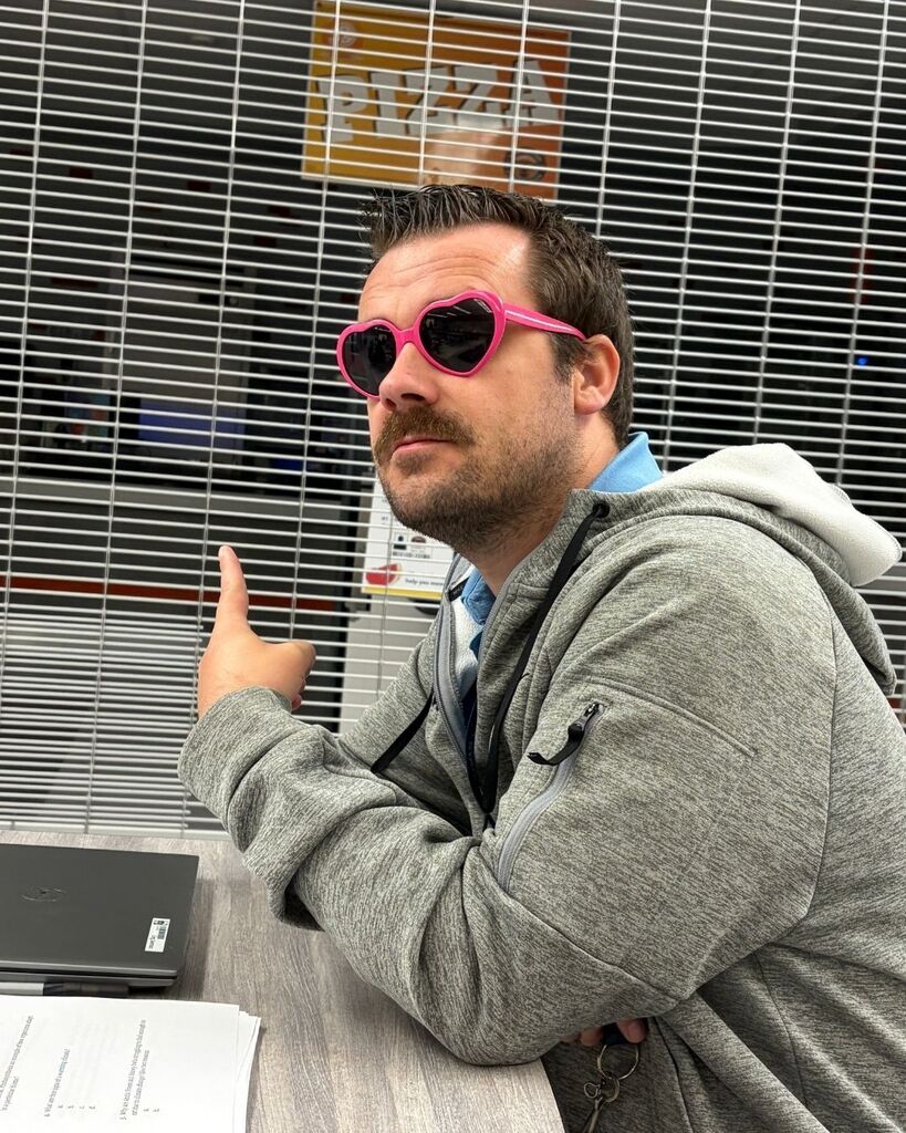 A teacher shows off his heart sunglasses