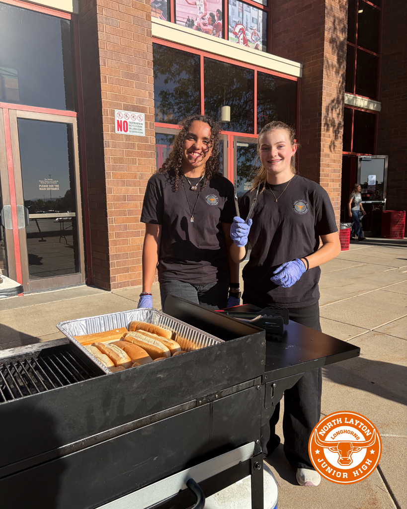Two SBO students working the grill at the community event
