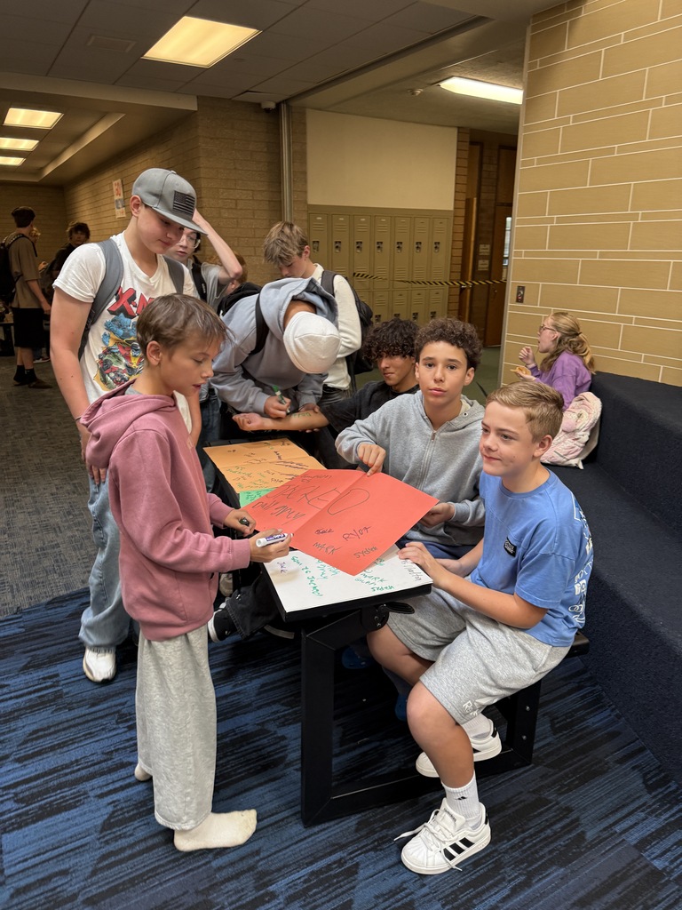 Another student signing a card. 