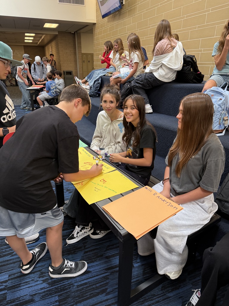 Student signing another card. 