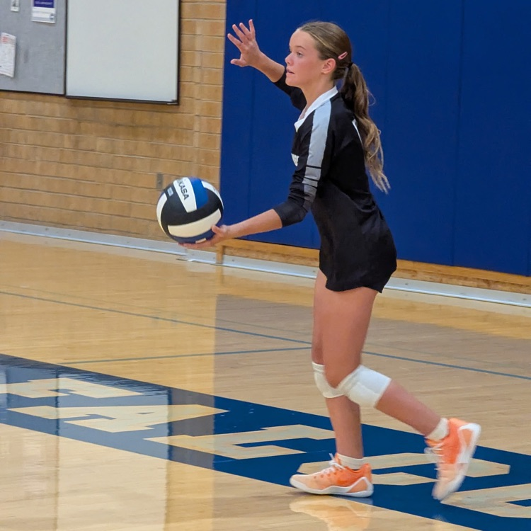 girl serving volleyball