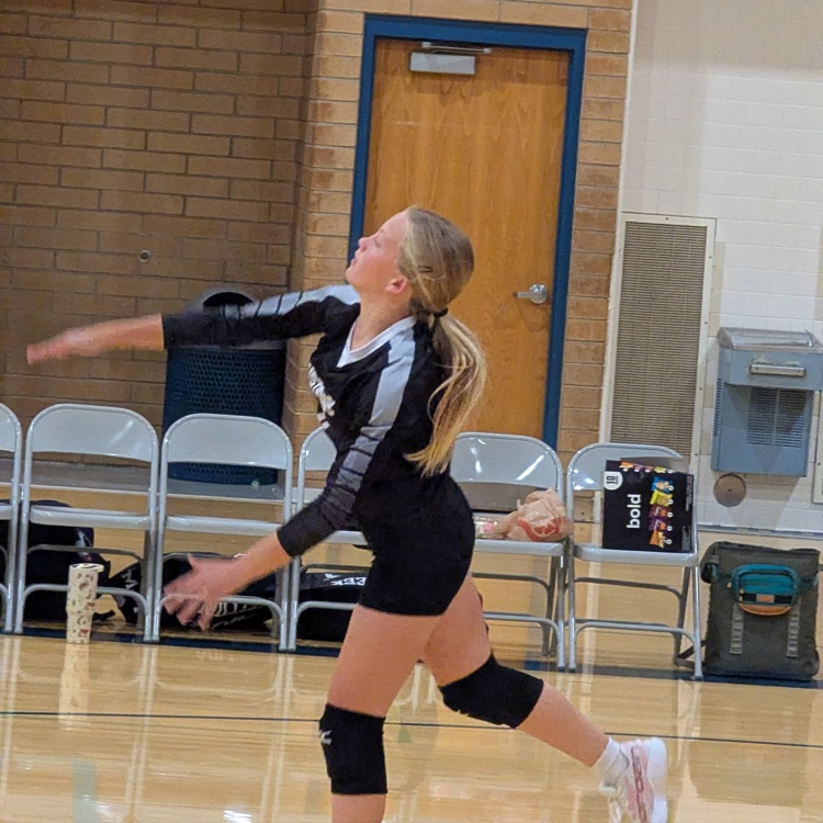 girl serving volleyball 