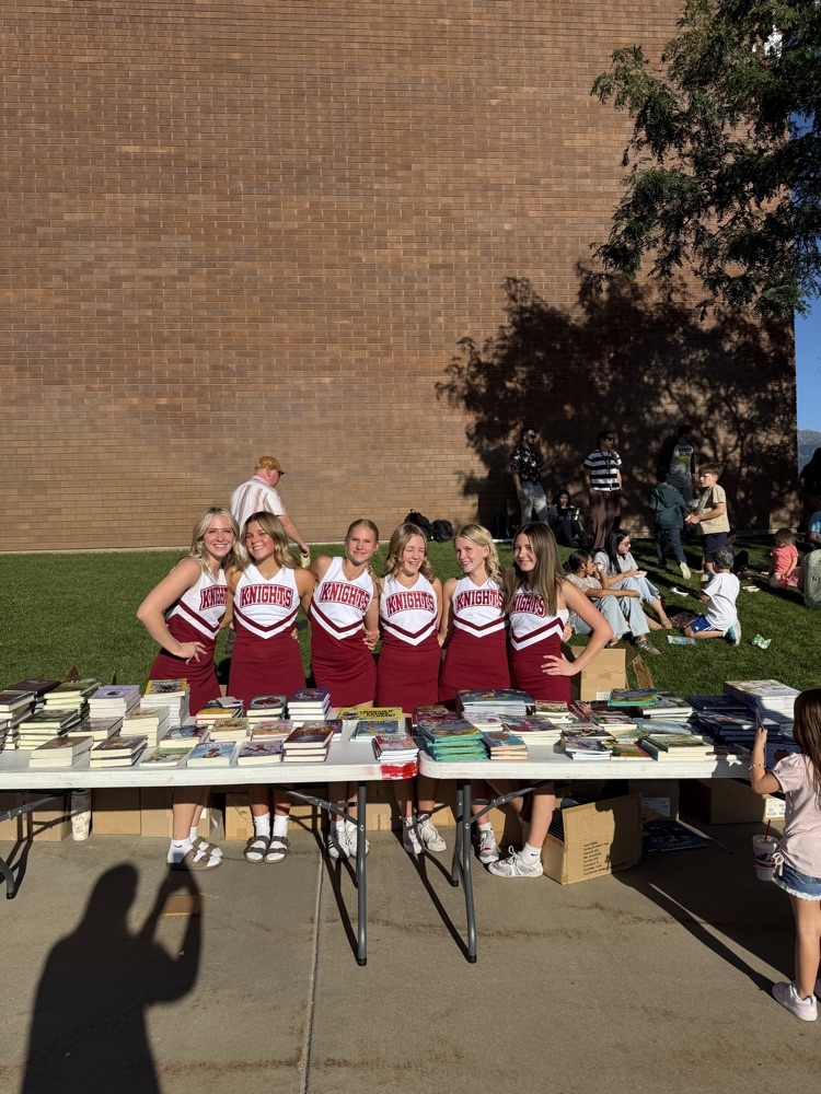 Cheer team handing out books