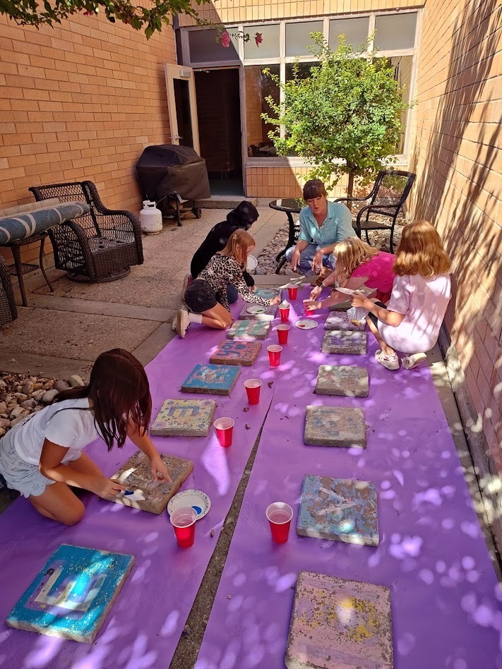 Students painting steppingstones.