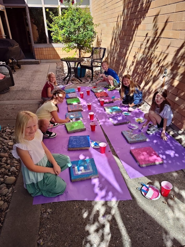 Students painting steppingstones.